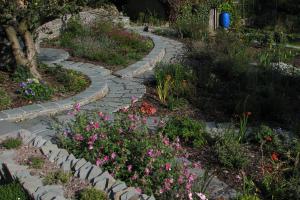 The garden has slate paths that sweep through large planting beds