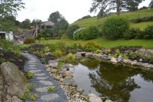 The size and shape of the pond fits into the space