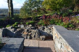 Stone wall, natural bedrock and planting 