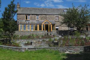 Oak framed sunroom built onto a traditional stone built farmhouse