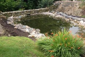 Stone wall dam with natural rock edges