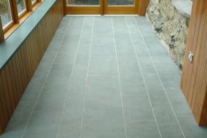 Polished slate floor laid in a contemporary random running bond