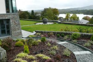 The gravel path sweeps through the planting in a curve leading to a small patio