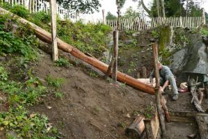 Landscaper at work on natural wood steps