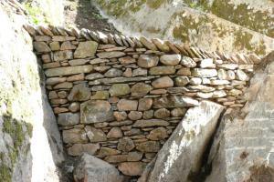 Curved stone wall in Cumbrian hillside garden